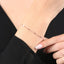 Elegante zilveren armband met roségouden afwerking en knopendesign